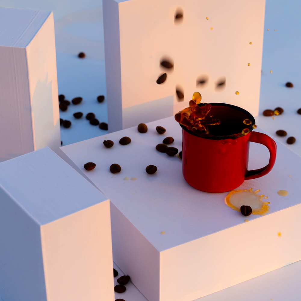 a cup of coffee sitting on top of a white box