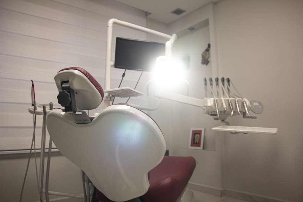 a dental room with a chair and a monitor