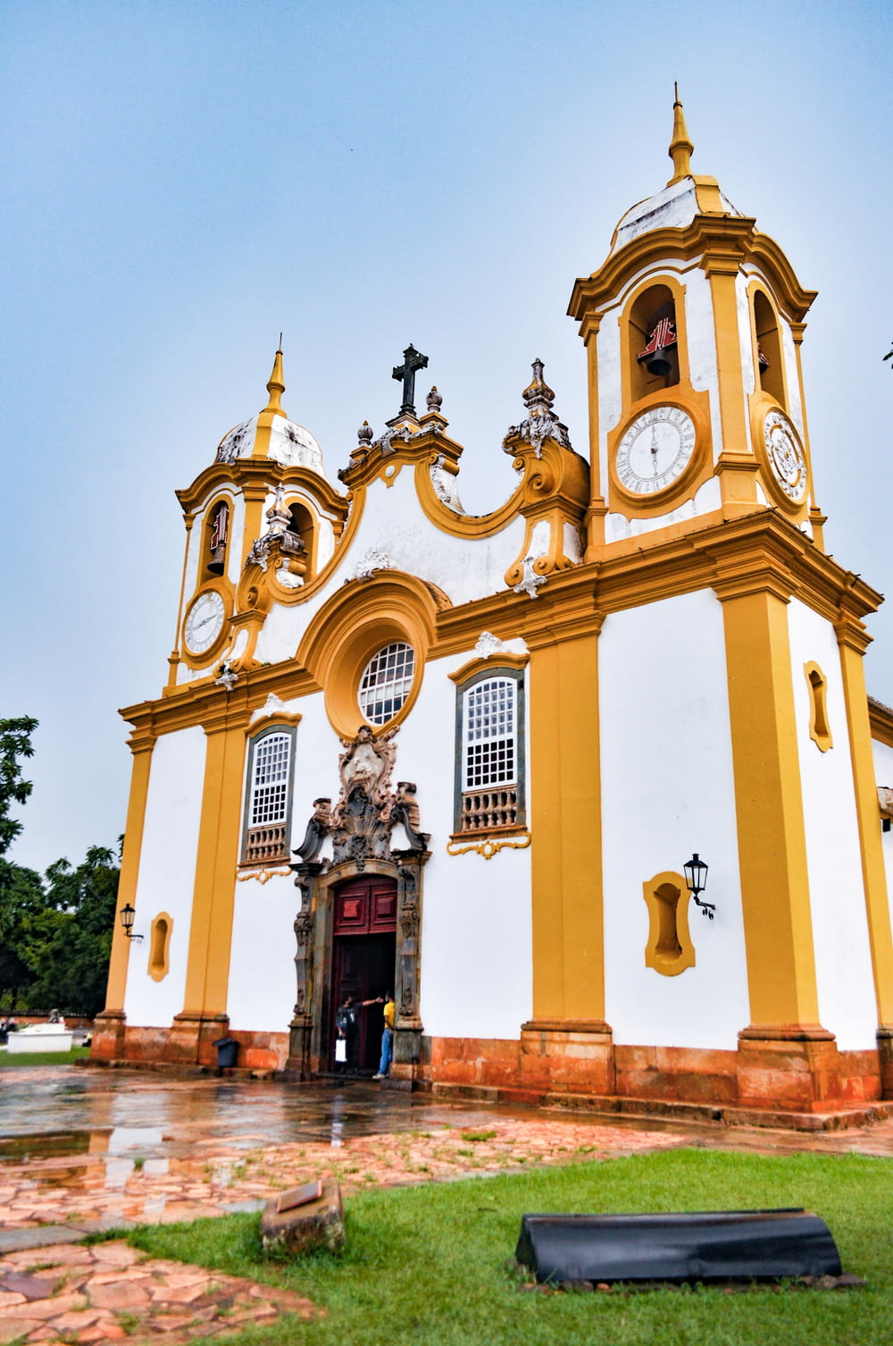 a yellow and white church with a clock tower
