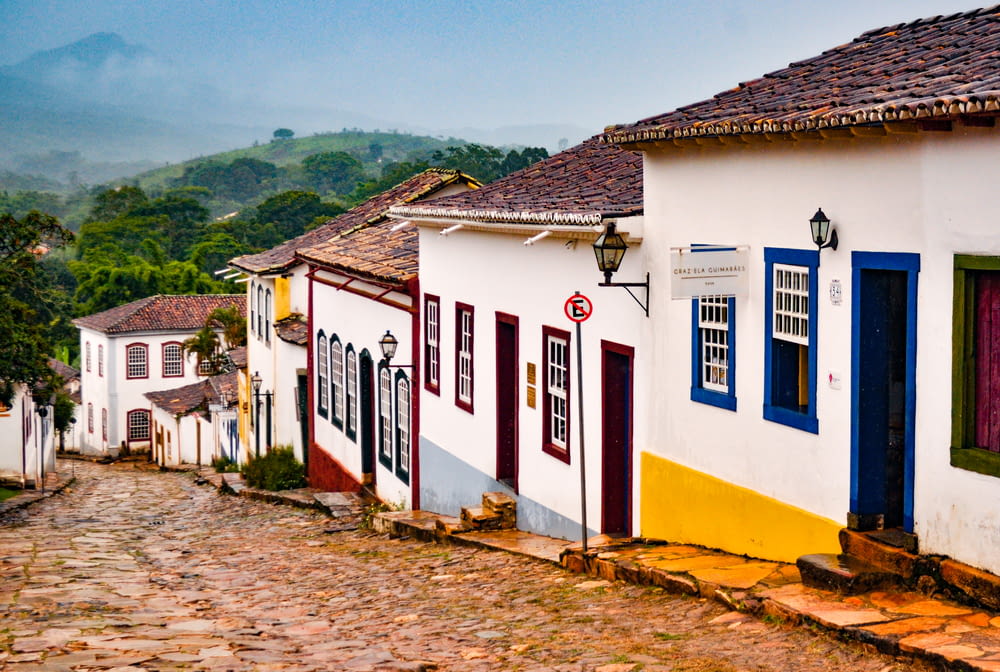 a cobblestone street lined with colorful houses