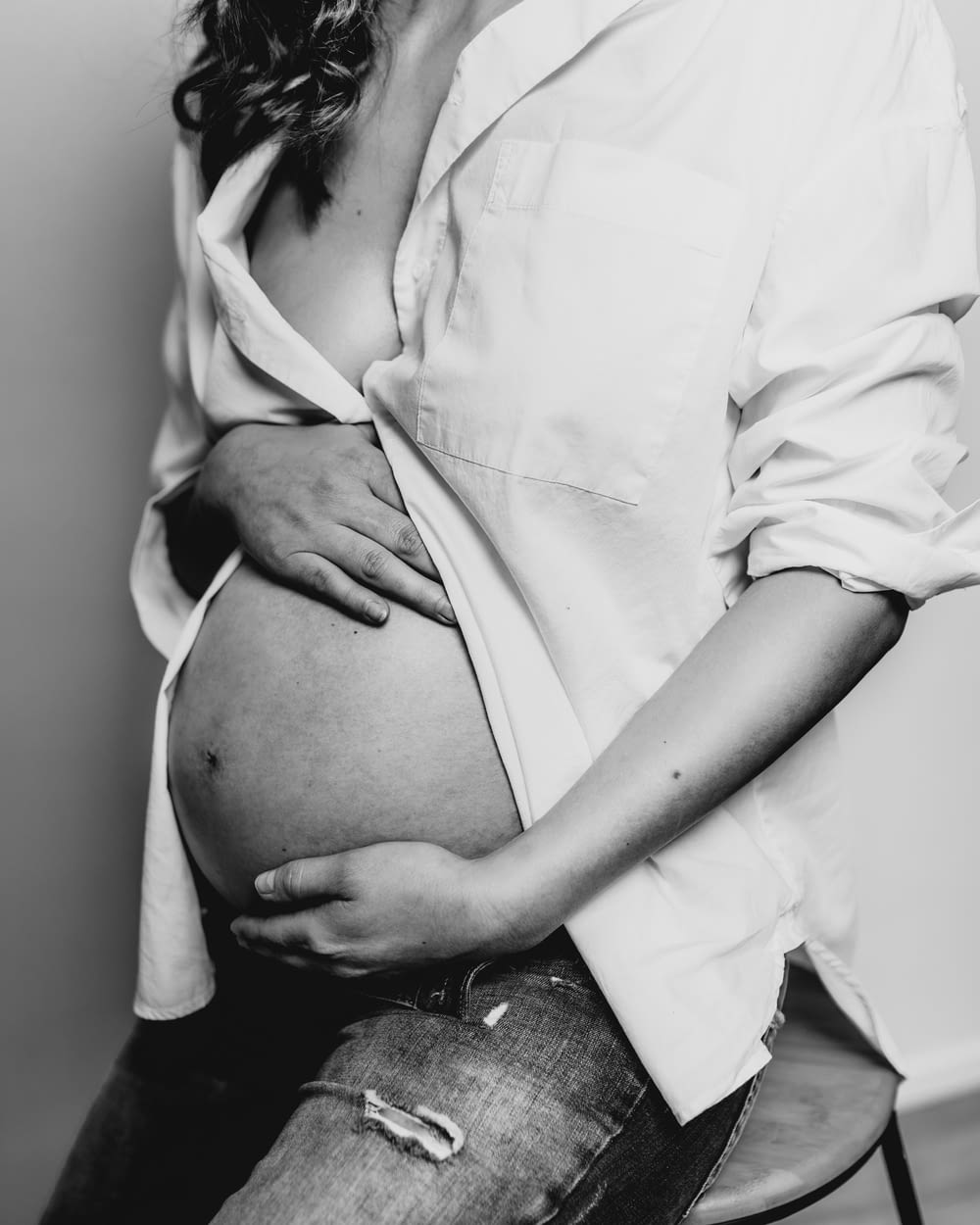 a black and white photo of a pregnant woman