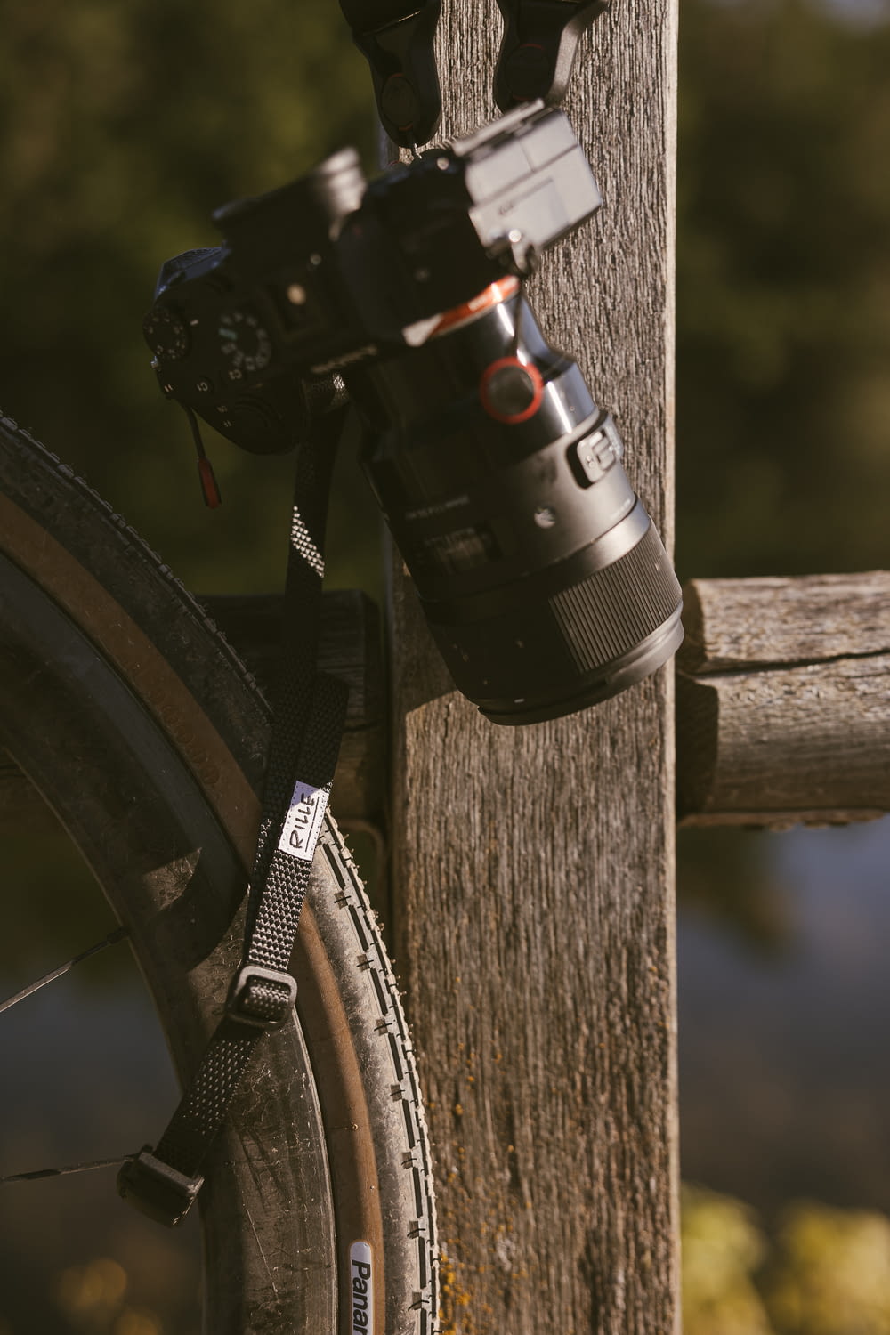 a camera attached to a wooden post next to a bicycle