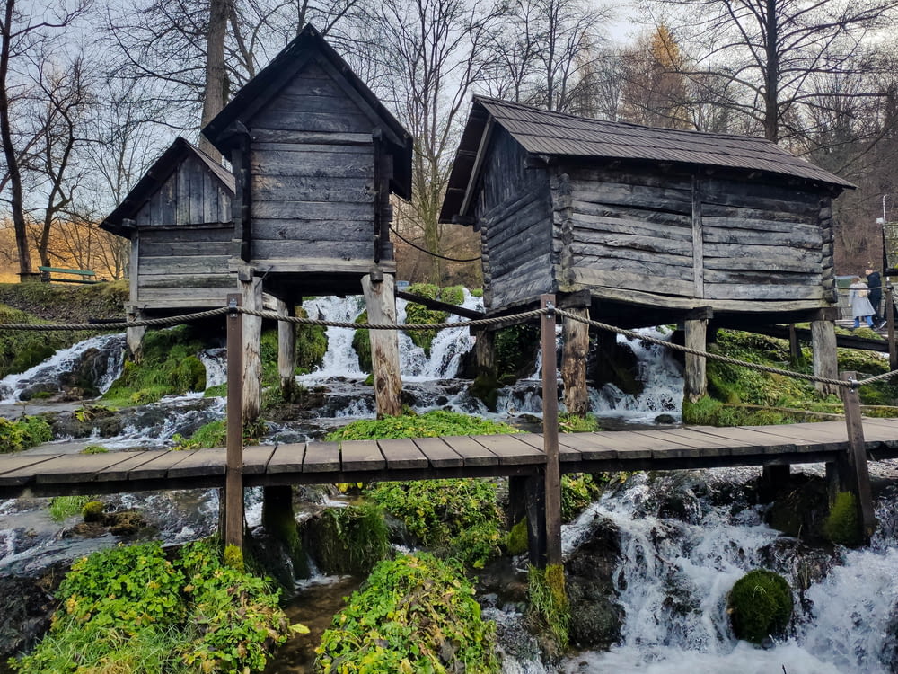 a couple of wooden buildings sitting on top of a river