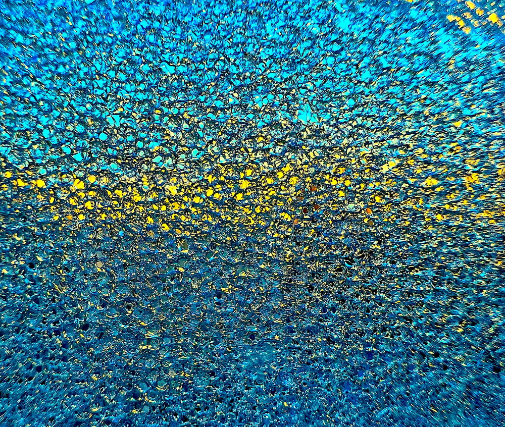 a blue and yellow background with a lot of small dots