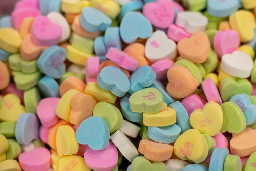 a pile of candy hearts sitting next to each other