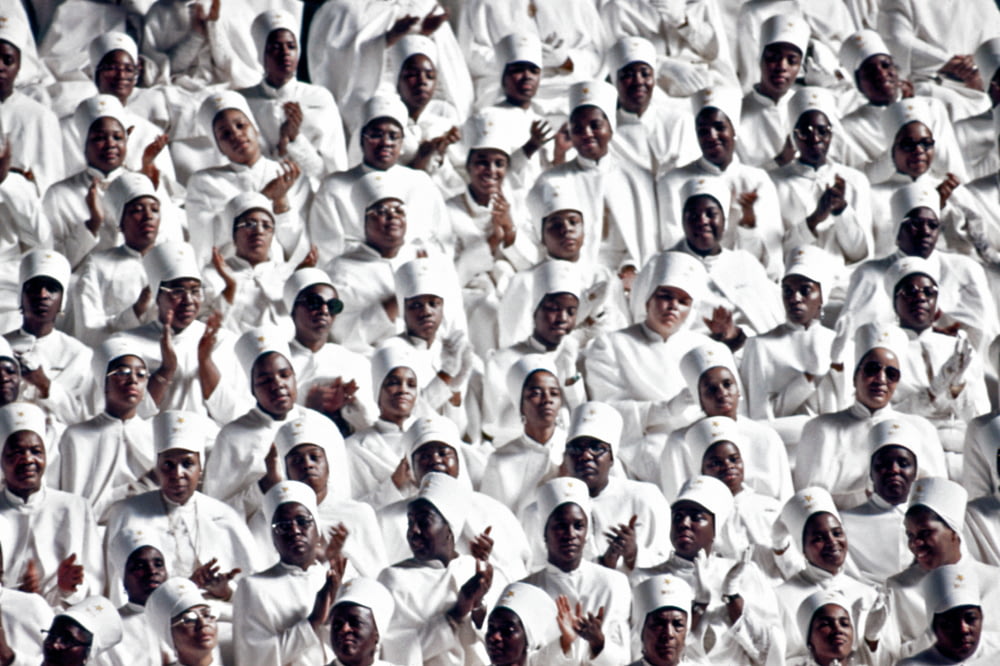 a large group of people in white outfits