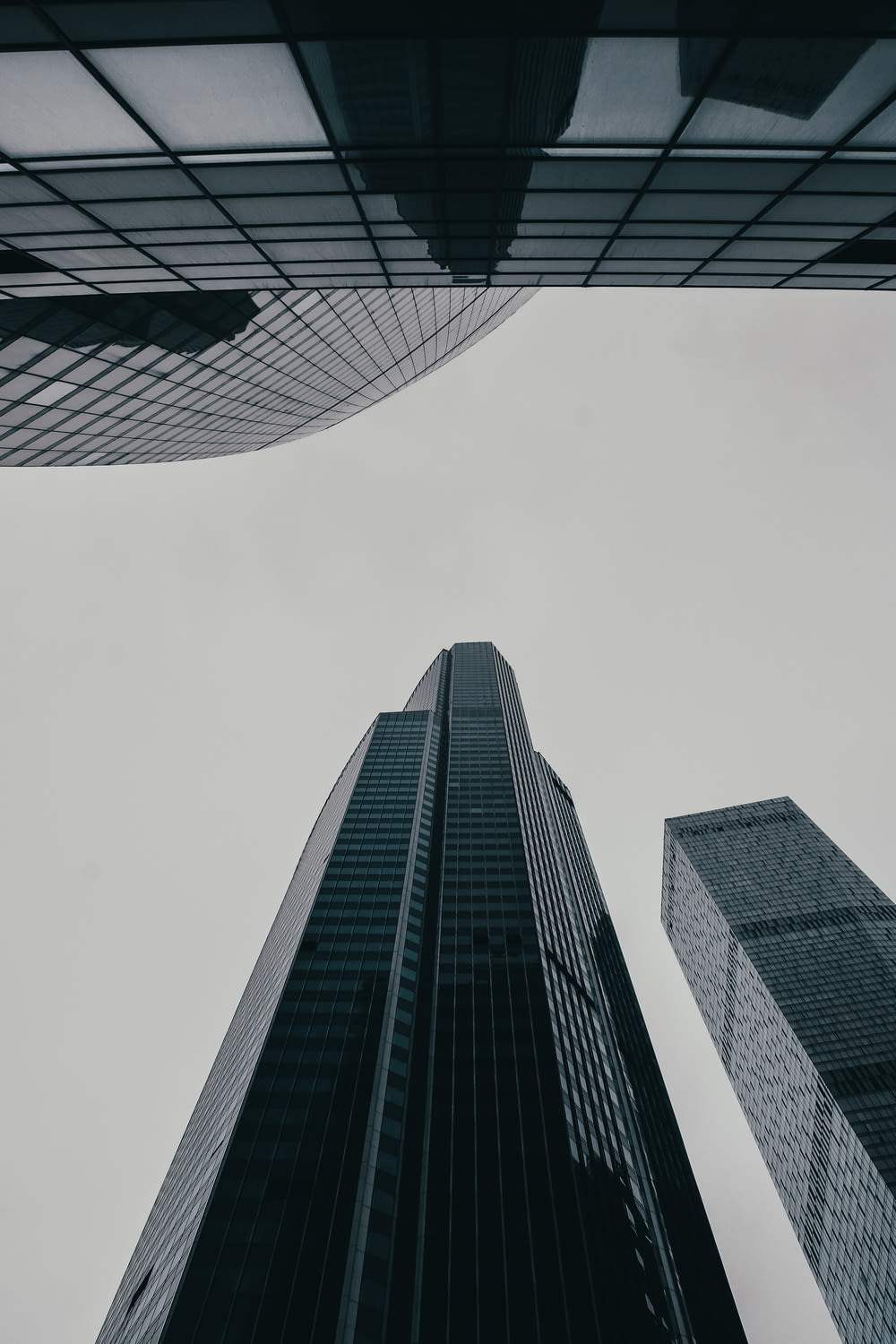 looking up at two tall skyscrapers in a city