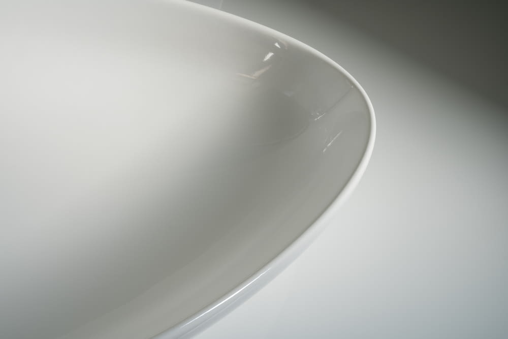 a close up of a white bowl on a table