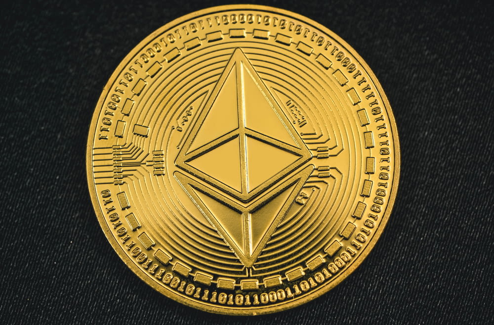 a gold coin with the symbol of ether on it