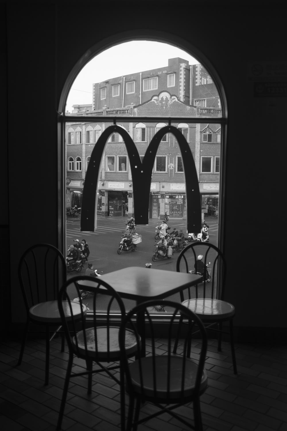 a black and white photo of a table and chairs
