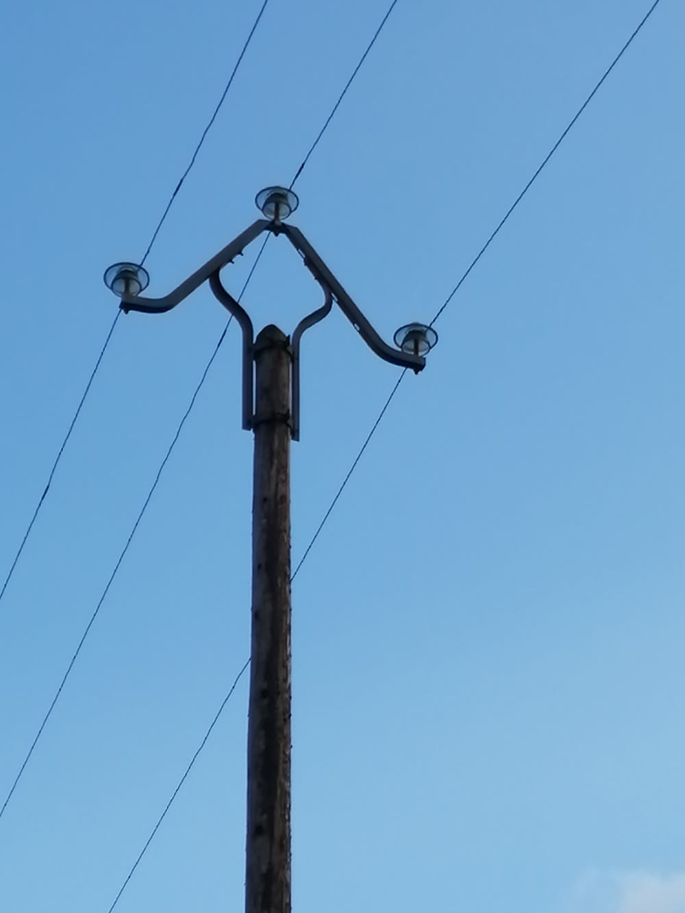 a telephone pole with two lights on top of it