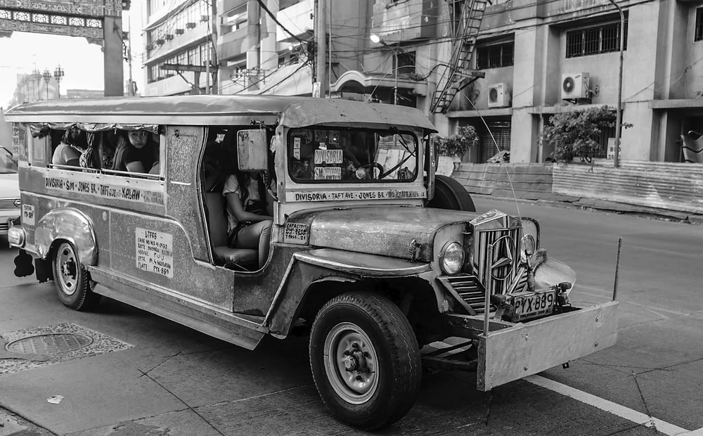 a black and white photo of an old bus