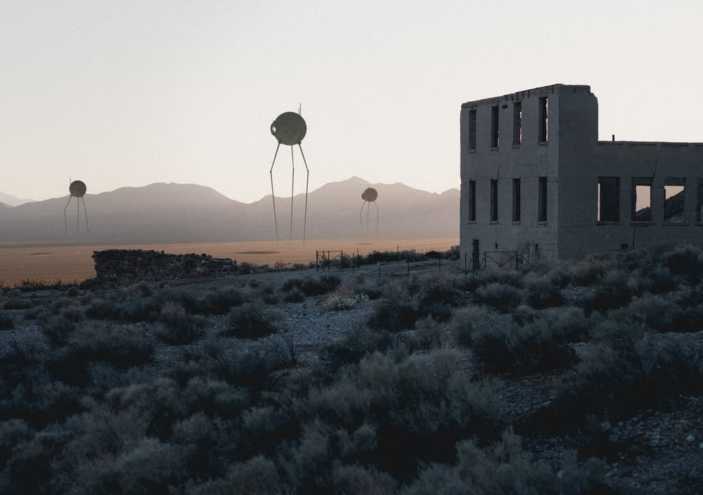 a couple of water towers sitting in the middle of a desert