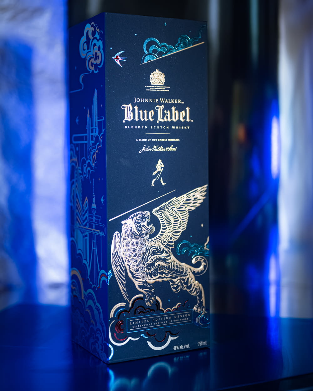 a bottle of blue label sitting on top of a table