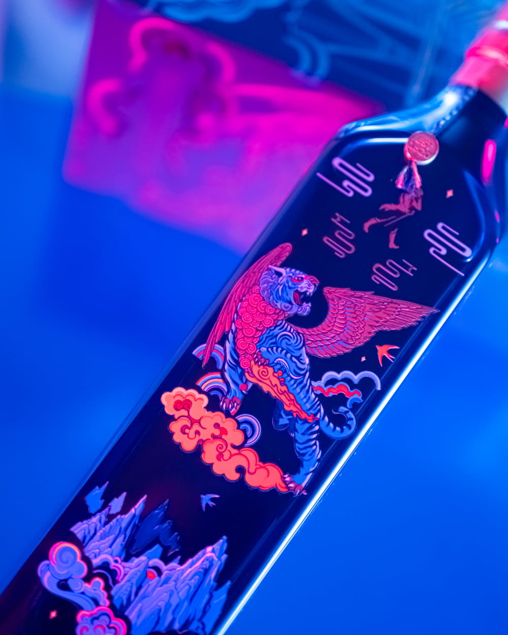 a bottle of liquor with a dragon design on it