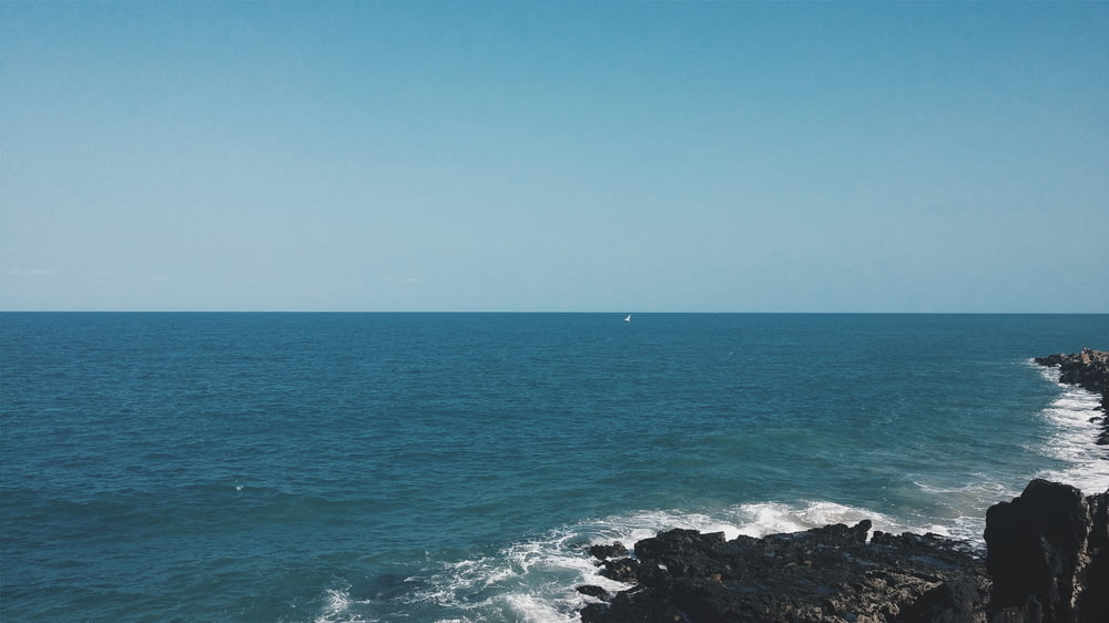 a view of the ocean from a rocky cliff