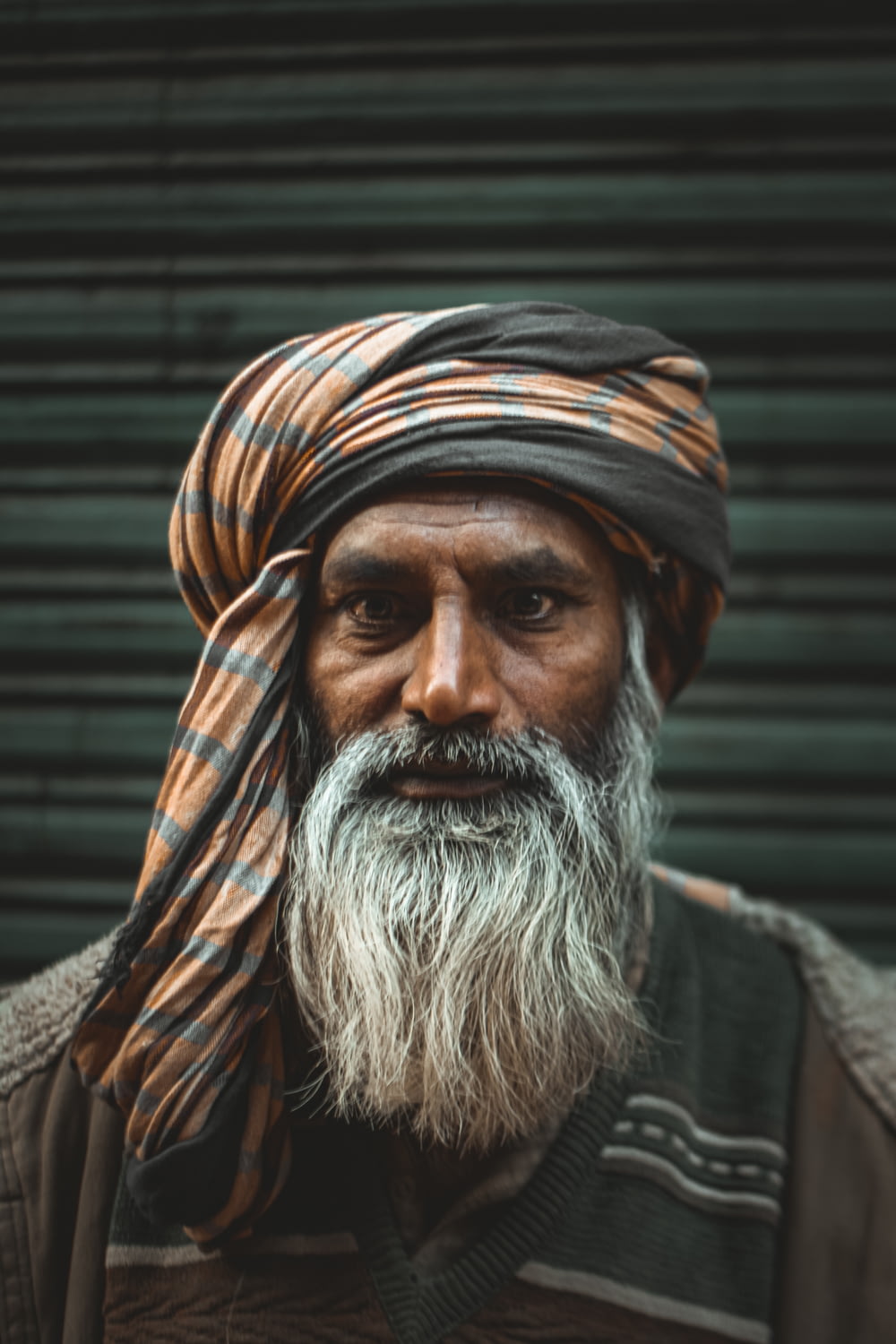 a man with a long white beard wearing a turban