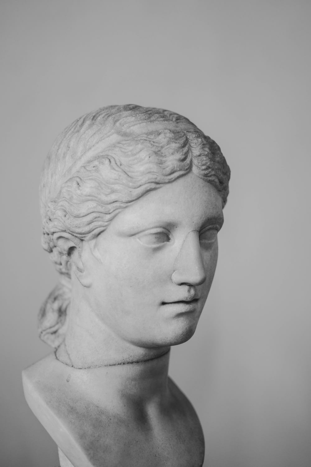 a black and white photo of a bust of a woman