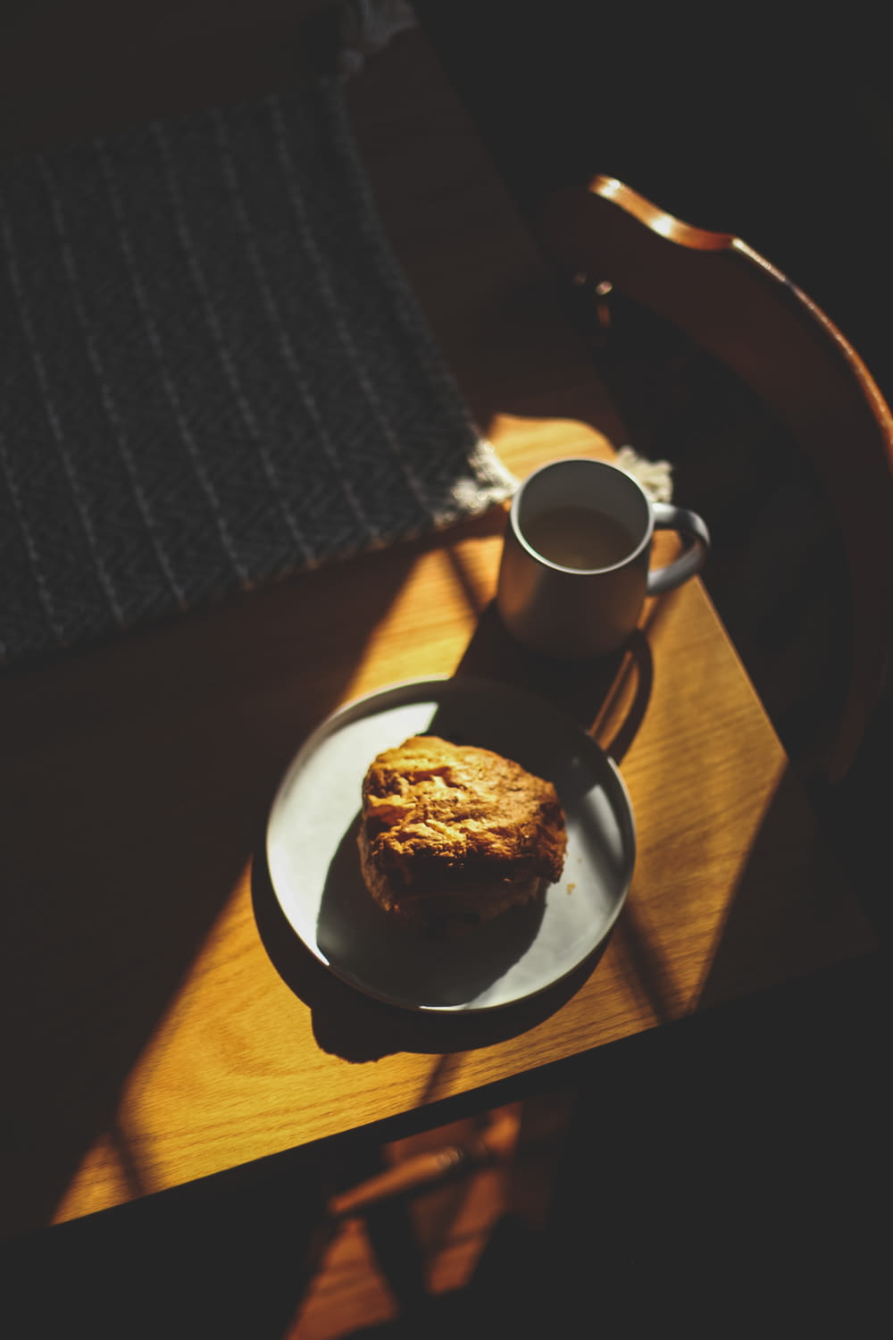 a cup of coffee and a muffin on a plate