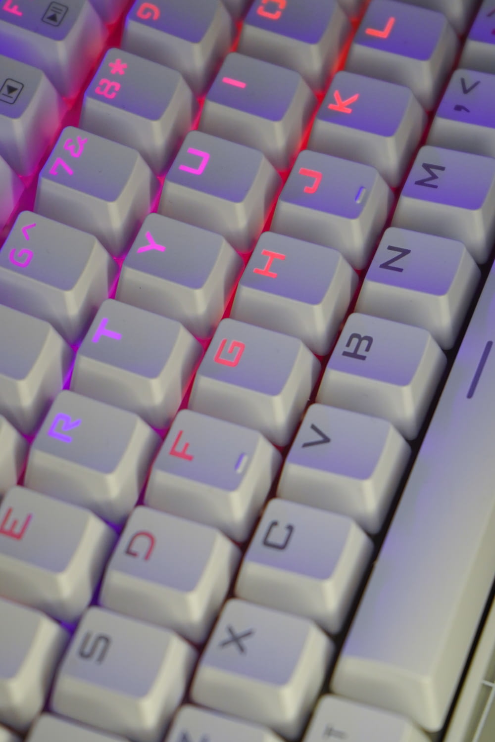 a close up of a keyboard with a red light on it
