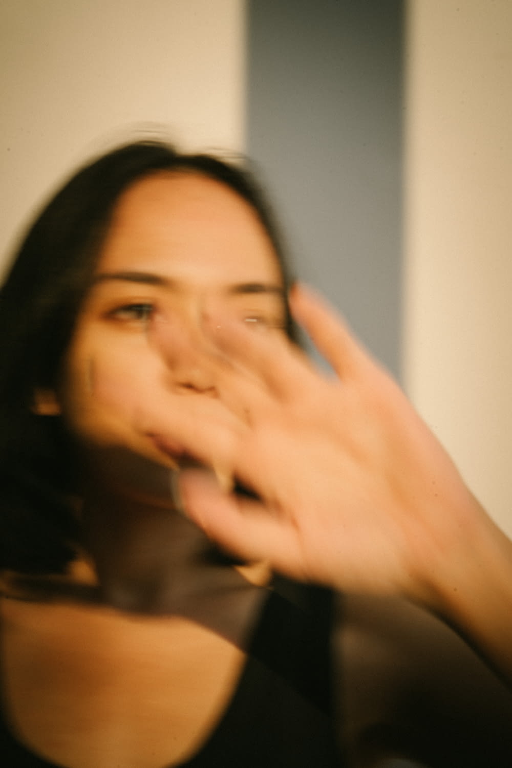 a blurry photo of a woman holding a cell phone