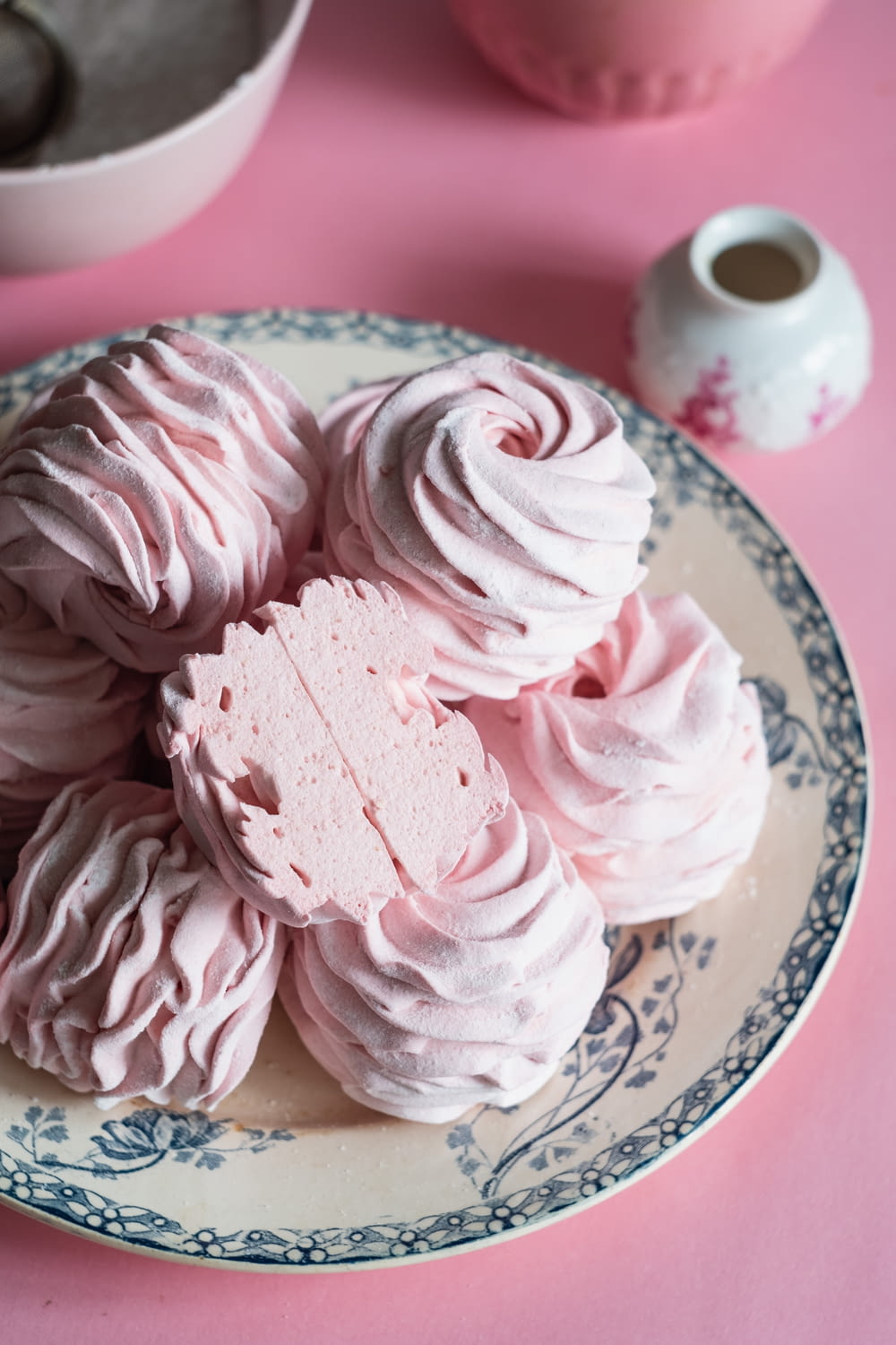 a plate of pink meringue on a pink table