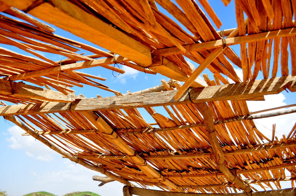 a close up of a wooden structure under a blue sky