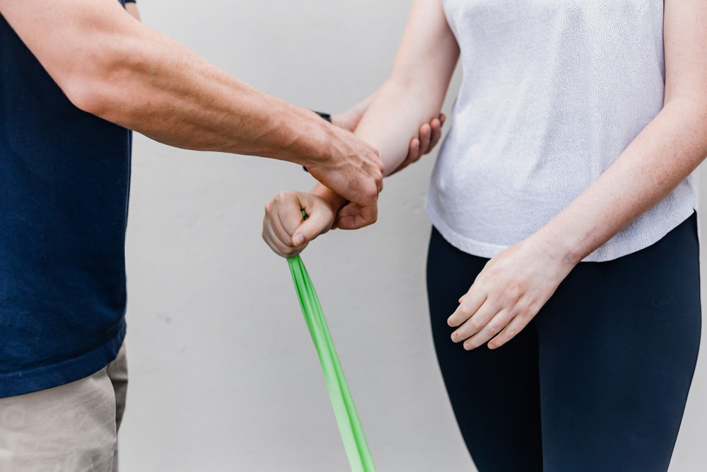 a man and a woman holding a green stick