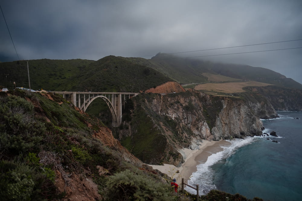 a path with trees on the side of Bixby Creek Bridge