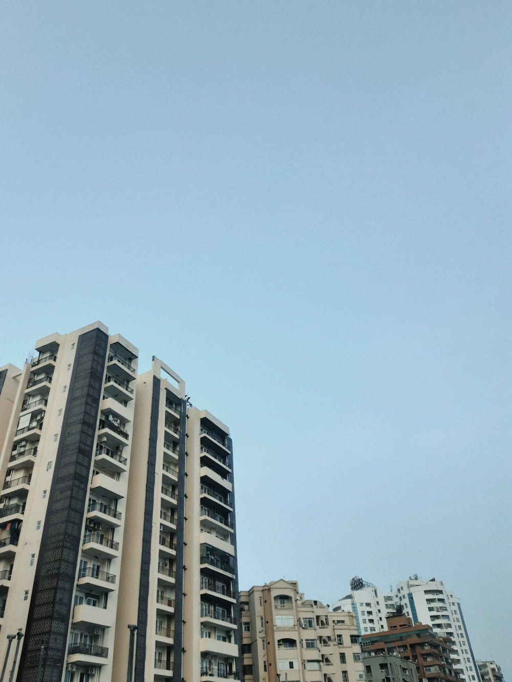 a very tall building sitting next to a bunch of tall buildings
