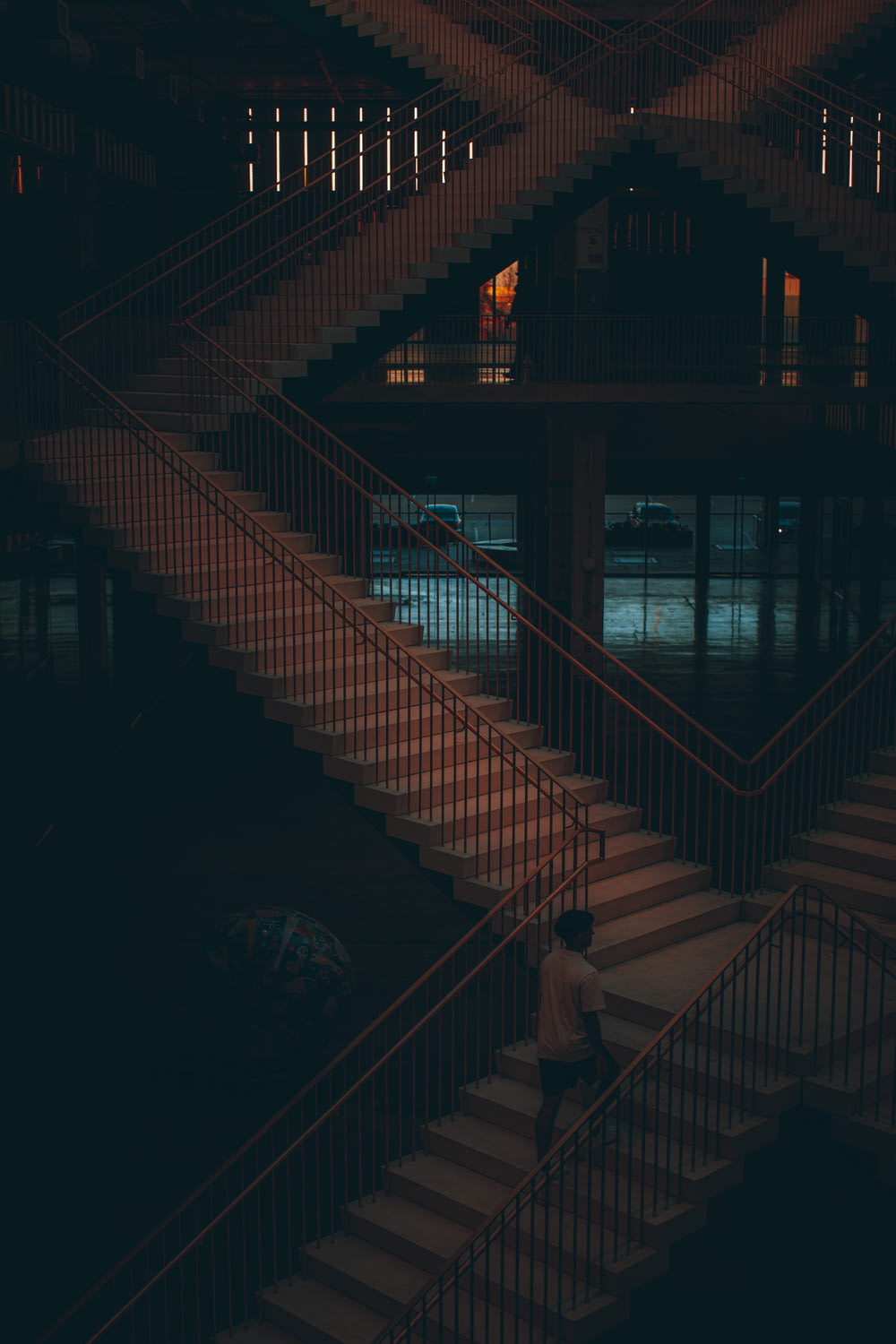 a man walking down a set of stairs at night