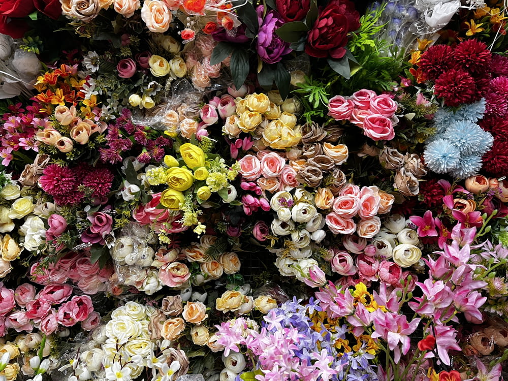 a bunch of flowers that are on a wall