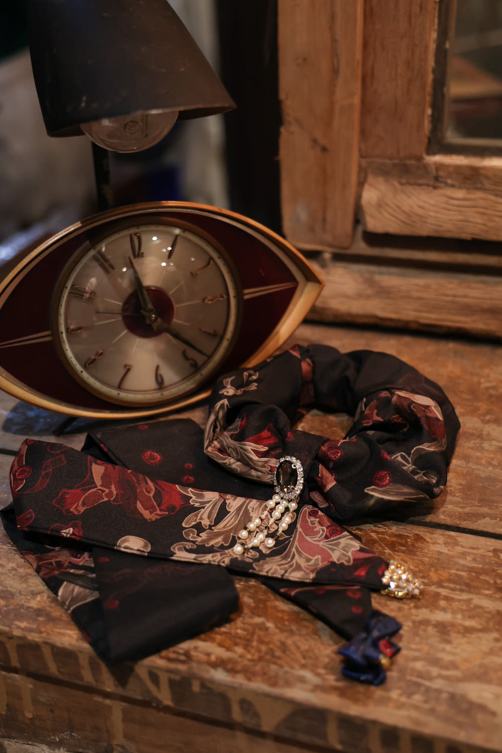 a clock and a scarf on a table