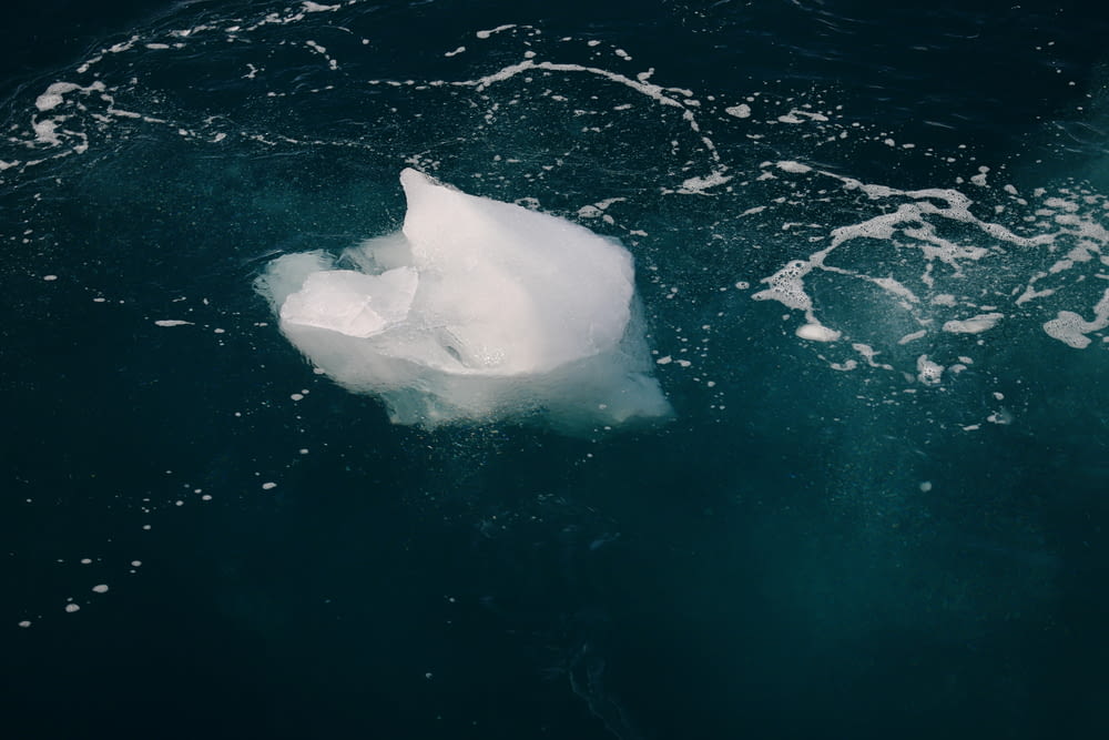 an iceberg floating in the water near the shore