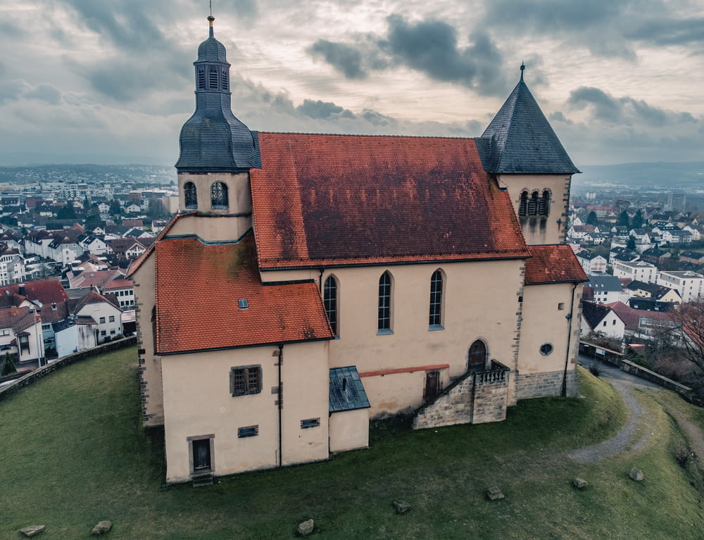 an old church on a hill overlooking a city