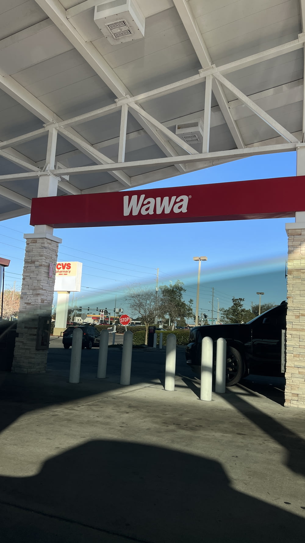 a red and white sign that reads wawa