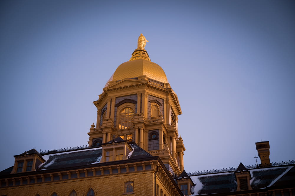 a tall building with a gold dome and a clock