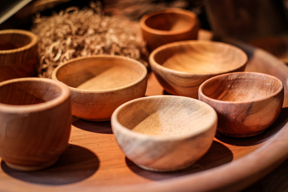 a wooden tray with wooden bowls on it