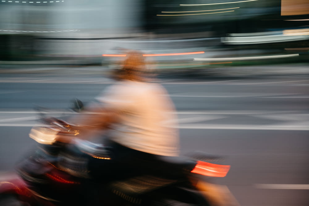 a blurry photo of a man riding a motorcycle