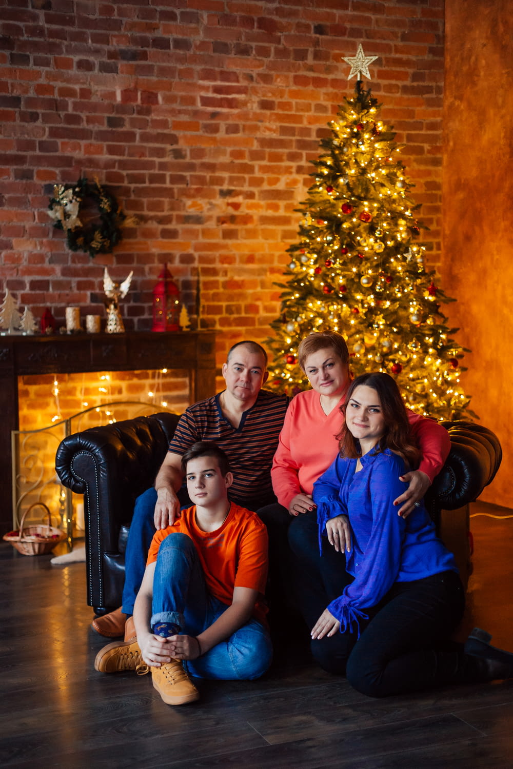 a family sitting in front of a christmas tree
