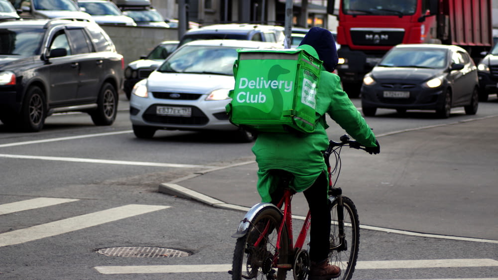 a person in a green outfit riding a bike
