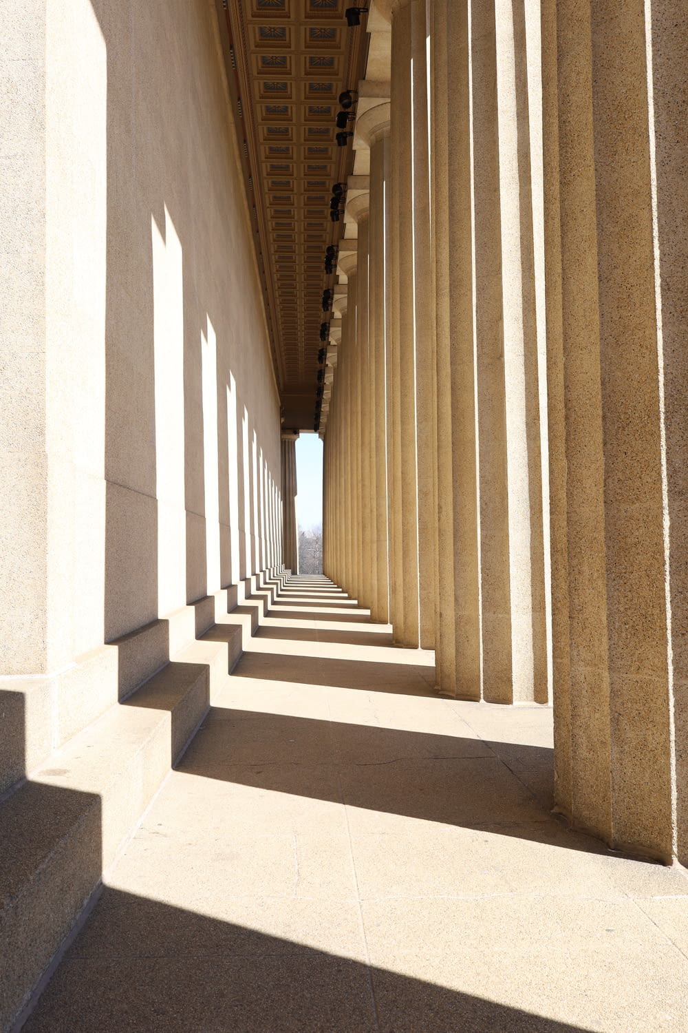 a long row of columns on the side of a building