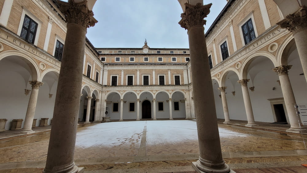 a courtyard with columns and arches in a building