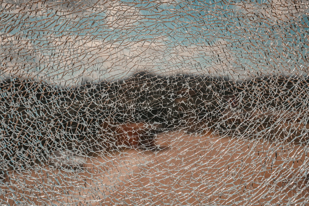 a close up of a piece of glass with a mountain in the background