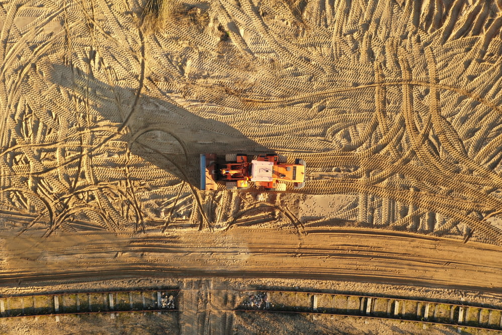 an aerial view of a tractor trailer in a field