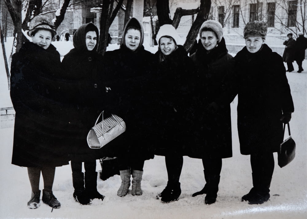 a group of women standing next to each other in the snow