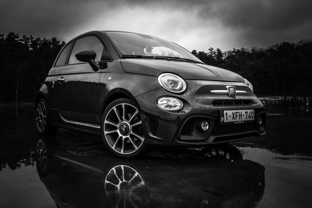 a black and white photo of a small car