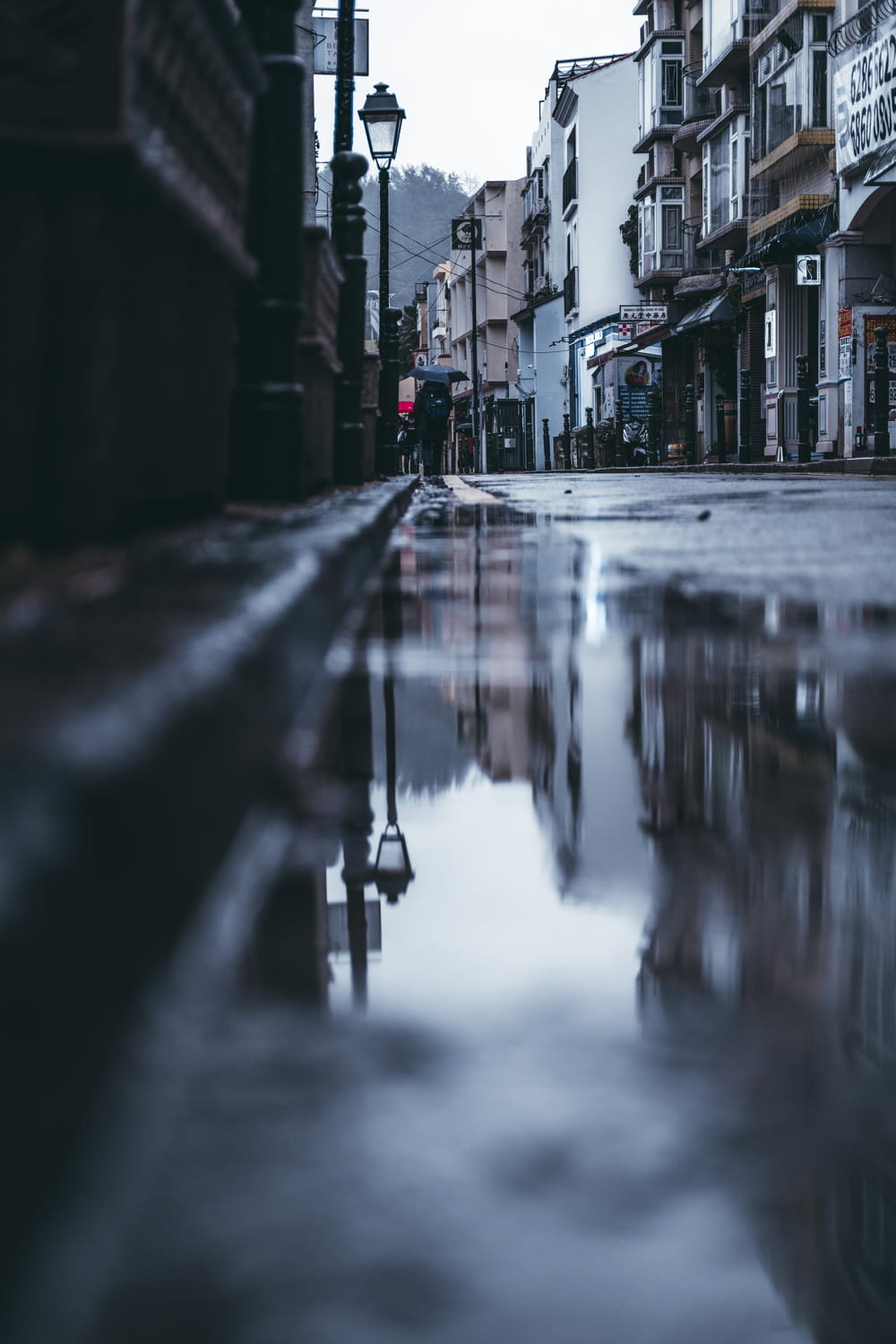 a city street with a puddle of water on the ground