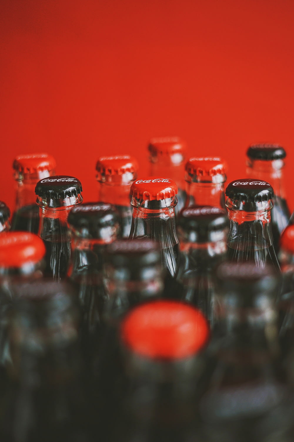 a close up of many bottles of soda