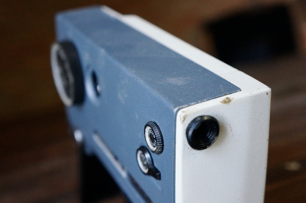 a close up of a blue and white speaker